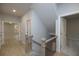 View of the home's second story hallway with wood floors, white doors and trim, and black railing at 504 Winston Croft Cir # 54, Johns Creek, GA 30022