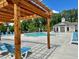 View of the community pool with lots of seating, shade, and a pool house at 504 Winston Croft Cir # 54, Johns Creek, GA 30022