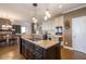 Kitchen island with granite countertop and dark wood cabinets at 5412 Wild Flower Ct, Powder Springs, GA 30127