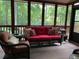 Relaxing screened porch with wicker furniture and wooded views at 5412 Wild Flower Ct, Powder Springs, GA 30127