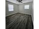 Bright bedroom with ceiling fan and wood-look flooring at 6658 Collins Ct, Riverdale, GA 30274