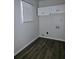 Laundry area with upper cabinets and vinyl plank flooring at 6658 Collins Ct, Riverdale, GA 30274