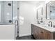 Modern bathroom with double vanity and a glass shower at 1573 Newton Se Ave, Atlanta, GA 30316