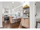 Modern kitchen with island, light wood cabinets, quartz countertops and stainless steel appliances at 1573 Newton Se Ave, Atlanta, GA 30316