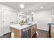 Modern kitchen with large island, stainless steel appliances and shaker style cabinets at 1573 Newton Se Ave, Atlanta, GA 30316