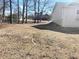 Backyard with sloped terrain and sparse vegetation at 3581 Drum Roll Ln, Snellville, GA 30039