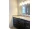 Bathroom with granite countertop, dark vanity, and updated lighting at 3581 Drum Roll Ln, Snellville, GA 30039