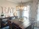 Bright dining area with a rustic wooden table and statement lighting at 3581 Drum Roll Ln, Snellville, GA 30039