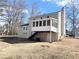 House exterior showcasing a screened porch and backyard at 3581 Drum Roll Ln, Snellville, GA 30039