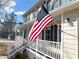 Two-story house with a front porch, white railings, and American flag at 3581 Drum Roll Ln, Snellville, GA 30039