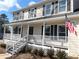 Two-story house with a front porch, white railings, and American flag at 3581 Drum Roll Ln, Snellville, GA 30039