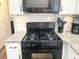 A black gas range with a pressure cook setting is featured in this kitchen at 3581 Drum Roll Ln, Snellville, GA 30039