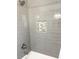 Shower with gray subway tile and a mosaic tile accent at 3581 Drum Roll Ln, Snellville, GA 30039