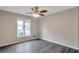 Bright bedroom with ceiling fan, large window, and laminate flooring at 2599 Fieldstone View Se Ln, Conyers, GA 30013