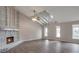 High-ceilinged living room with fireplace and wood-look floors at 2599 Fieldstone View Se Ln, Conyers, GA 30013