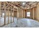 Unfinished basement shows the framework of the walls and a single window at 7650 Abbey Glen Dr, Cumming, GA 30028