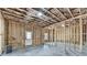 Unfinished basement shows the framework of the walls, door, and window at 7650 Abbey Glen Dr, Cumming, GA 30028