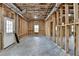 Unfinished basement featuring framed walls, concrete floors, and insulation at 7650 Abbey Glen Dr, Cumming, GA 30028