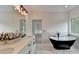 Luxurious bathroom featuring a standalone tub, double vanity with marble countertops, and modern fixtures at 7650 Abbey Glen Dr, Cumming, GA 30028