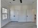 Bedroom with light gray floors, large closet, and doorway to the hall at 7650 Abbey Glen Dr, Cumming, GA 30028