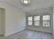 Bedroom featuring light gray floors and a large bank of three windows at 7650 Abbey Glen Dr, Cumming, GA 30028