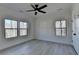 Bedroom with light gray floors, large closet, ceiling fan and two large windows at 7650 Abbey Glen Dr, Cumming, GA 30028