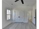 Bedroom with light gray floors, window, large closet, and doorway to the hall at 7650 Abbey Glen Dr, Cumming, GA 30028