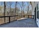 Wide wooden deck with dark railing that is perfect for outdoor relaxation and entertaining at 7650 Abbey Glen Dr, Cumming, GA 30028