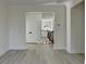 Hallway with light gray floors, and view of a staircase at 7650 Abbey Glen Dr, Cumming, GA 30028