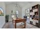 Charming home office with vaulted ceiling, built-in shelving, and a well-lit work space at 7650 Abbey Glen Dr, Cumming, GA 30028