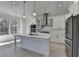 Modern kitchen with stainless steel appliances, quartz countertops and an island with pendant lights at 7650 Abbey Glen Dr, Cumming, GA 30028