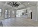 Open floor plan with large windows, white trim and archways leading to kitchen at 7650 Abbey Glen Dr, Cumming, GA 30028