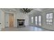 Bright main bedroom with a stone fireplace, coffered ceiling, and access to a private balcony at 7650 Abbey Glen Dr, Cumming, GA 30028