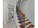 Elegant staircase with dark wood and metal accents at 7650 Abbey Glen Dr, Cumming, GA 30028