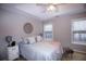 Bright bedroom with ceiling fan and ample natural light at 740 Abbotts Mill Ct, Johns Creek, GA 30097