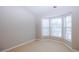 Bright bedroom featuring a bay window and neutral wall colors at 740 Abbotts Mill Ct, Johns Creek, GA 30097