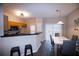Kitchen dining area with breakfast bar and modern light fixtures at 740 Abbotts Mill Ct, Johns Creek, GA 30097