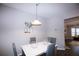 Bright dining room with white table and gray chairs at 740 Abbotts Mill Ct, Johns Creek, GA 30097
