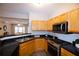 Modern kitchen with stainless steel appliances and light wood cabinets at 740 Abbotts Mill Ct, Johns Creek, GA 30097