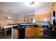 Eat-in kitchen with breakfast bar, stainless steel appliances, and wood cabinets at 740 Abbotts Mill Ct, Johns Creek, GA 30097