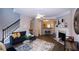 Open-concept living room with modern decor, a fireplace, and seamless flow to the kitchen area with bar seating at 740 Abbotts Mill Ct, Johns Creek, GA 30097