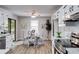 Open kitchen/dining area with stainless steel appliances, backyard view, and luxury vinyl plank flooring at 10213 Tall Pine, Villa Rica, GA 30180