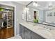 Spa-like bathroom with double vanity, marble countertop and large mirror at 1791 Walthall Nw Dr, Atlanta, GA 30318