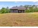 Gray house exterior with covered patio and grassy yard at 458 Florence Rd, Douglasville, GA 30134