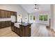 Open concept kitchen with island, dark cabinets & black countertops at 458 Florence Rd, Douglasville, GA 30134