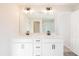 Bathroom with double vanity, modern lighting, and white cabinets at 135 Bluffington Way, Marietta, GA 30066