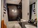 Clean bathroom with dark tile, shower/tub combo and granite vanity at 2587 Alvecot Cir, Atlanta, GA 30339