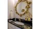 Elegant bathroom with a black granite vanity and gold accents at 2587 Alvecot Cir, Atlanta, GA 30339