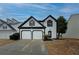 Two-story house with white siding, black accents, and a two-car garage at 2587 Alvecot Cir, Atlanta, GA 30339