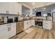 Modern kitchen with white cabinets, stainless steel appliances, and granite countertops at 2587 Alvecot Cir, Atlanta, GA 30339